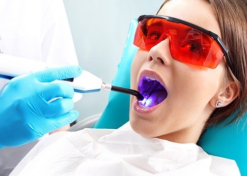 Woman receiving dental sealant treatment