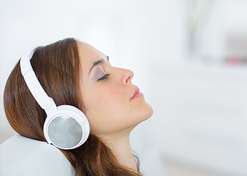 Relaxed woman with noise cancelling headphones